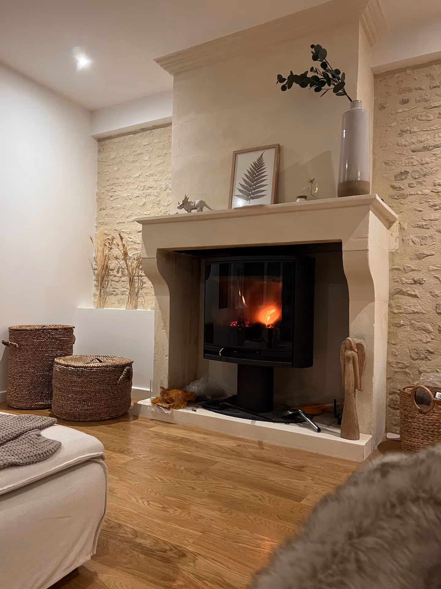Living room with fireplace and stone wall